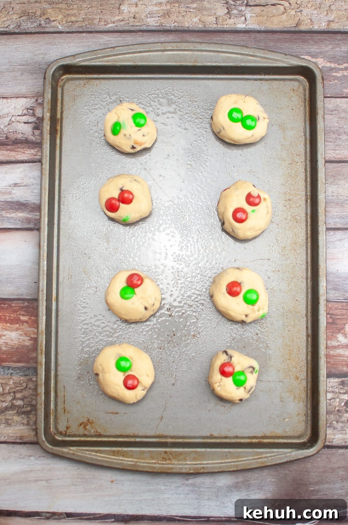 balls of christmas cookie dough on a metal baking sheet