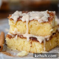 Gooey Snickerdoodle Bars with Cinnamon Frosting Recipe 8 two bars stacked on top of each other with frosting dripped.