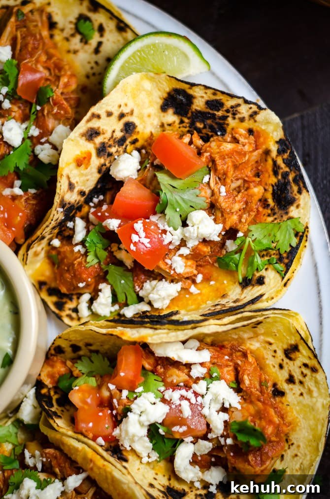 Spicy Slow-Cooker Shredded Mexican Chicken Recipe 7 Slow Cooker Spicy Shredded Mexican Chicken. Almost as easy to make as it is delicious. Great for tacos, enchiladas, burritos, and more! | hostthetoast.com