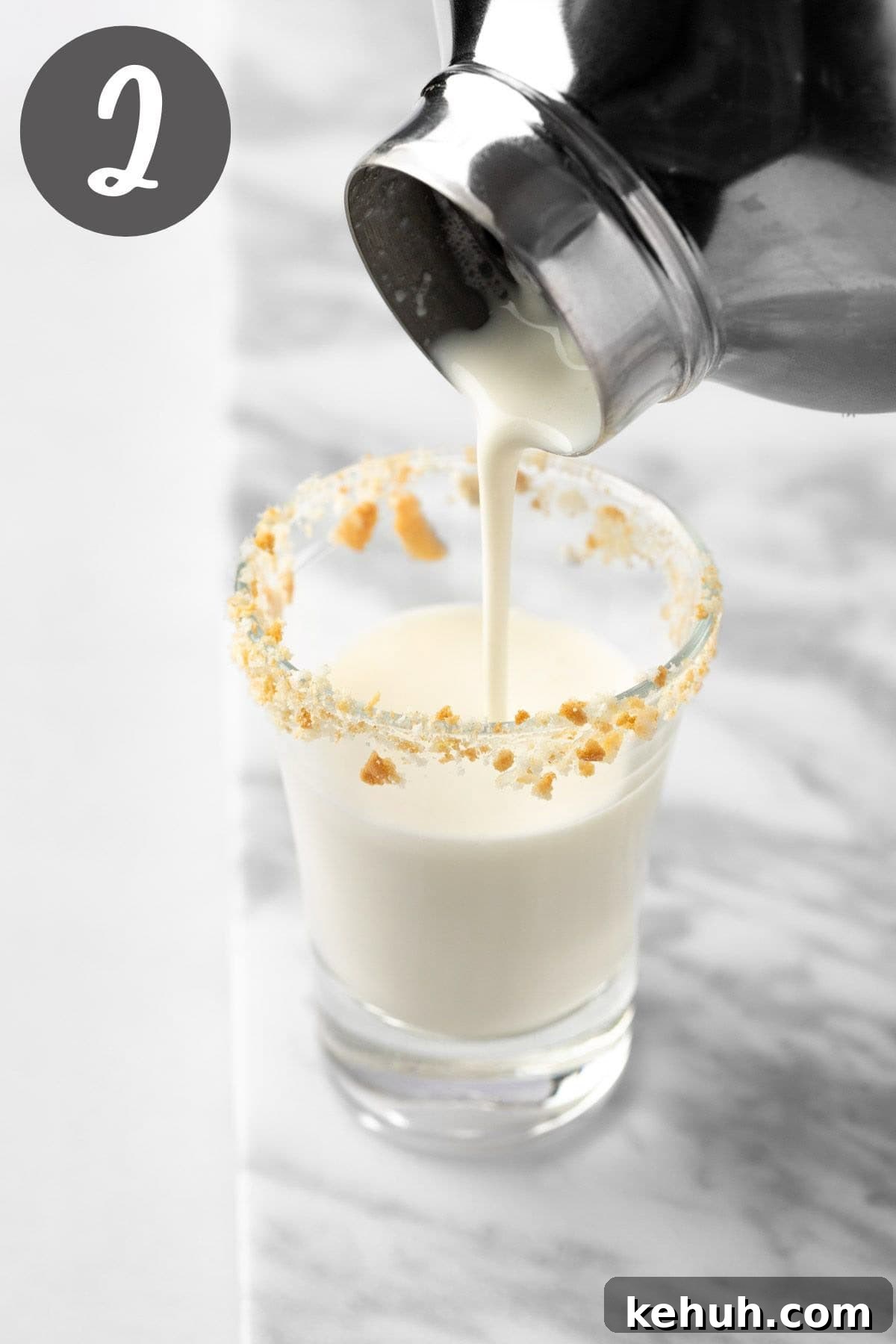 Key Lime Pie Shot Recipe: How to Make the Classic Cocktail Shooter 5 Pouring the key lime pie shot from the cocktail glass into the shot glass.