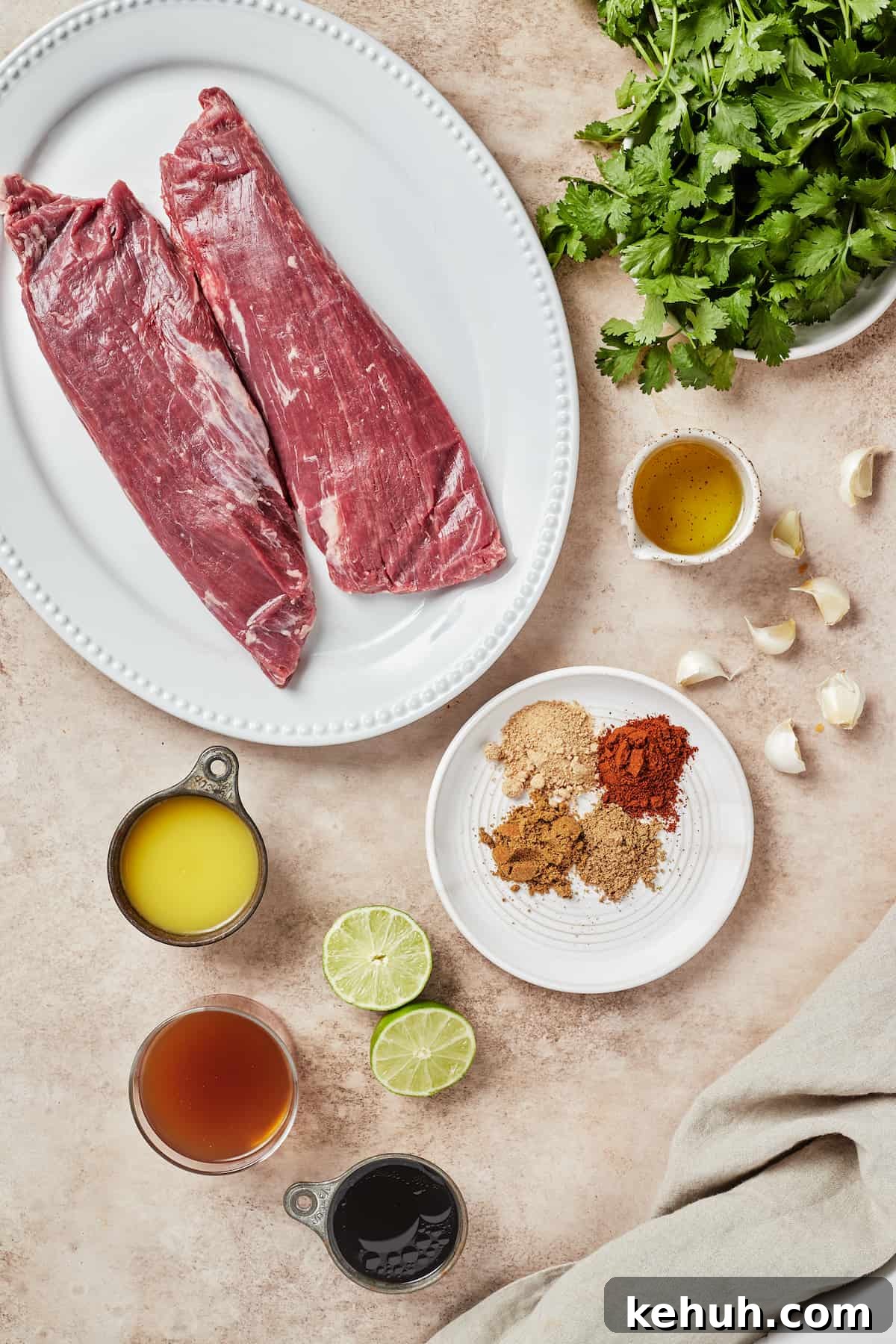 Instant Pot Carne Asada Recipe — Quick Tender Steak Dinner 4 From top left: Flank steak pieces, fresh cilantro, avocado oil, garlic, spices, lime halves, tamari sauce, beef broth, orange juice.