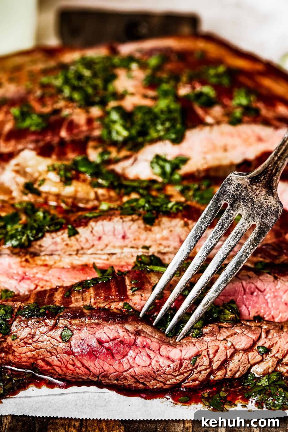 Instant Pot Carne Asada Recipe — Quick Tender Steak Dinner 8 Side view of sliced flank steak with a fork.