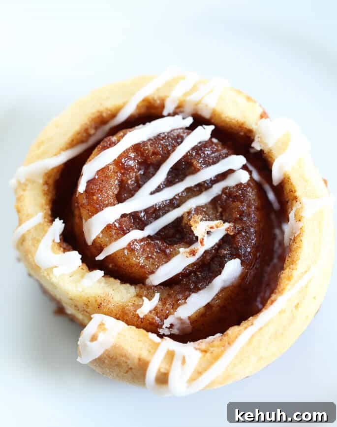 Cinnamon Rolls Without Gluten or Yeast: Soft, Fluffy Recipe 2 Overhead view of a cinnamon bun with white frosting