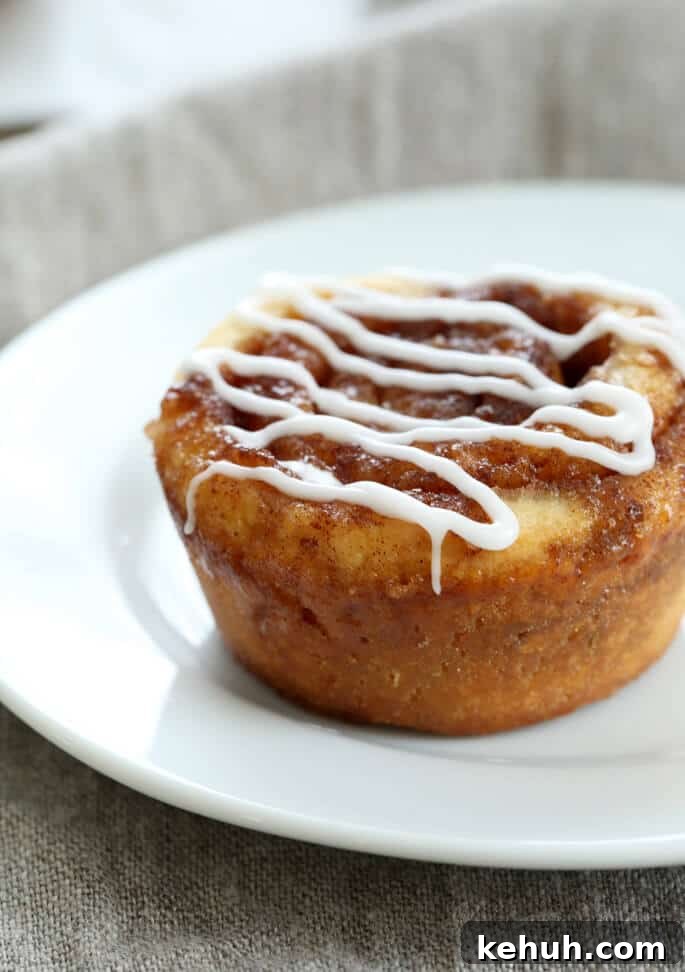 Cinnamon Rolls Without Gluten or Yeast: Soft, Fluffy Recipe 5 A close up of a cinnamon bun on a white plate