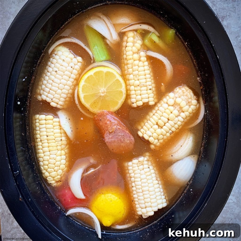 overhead shot of adding uncooked seafood boil in a black slow cooker