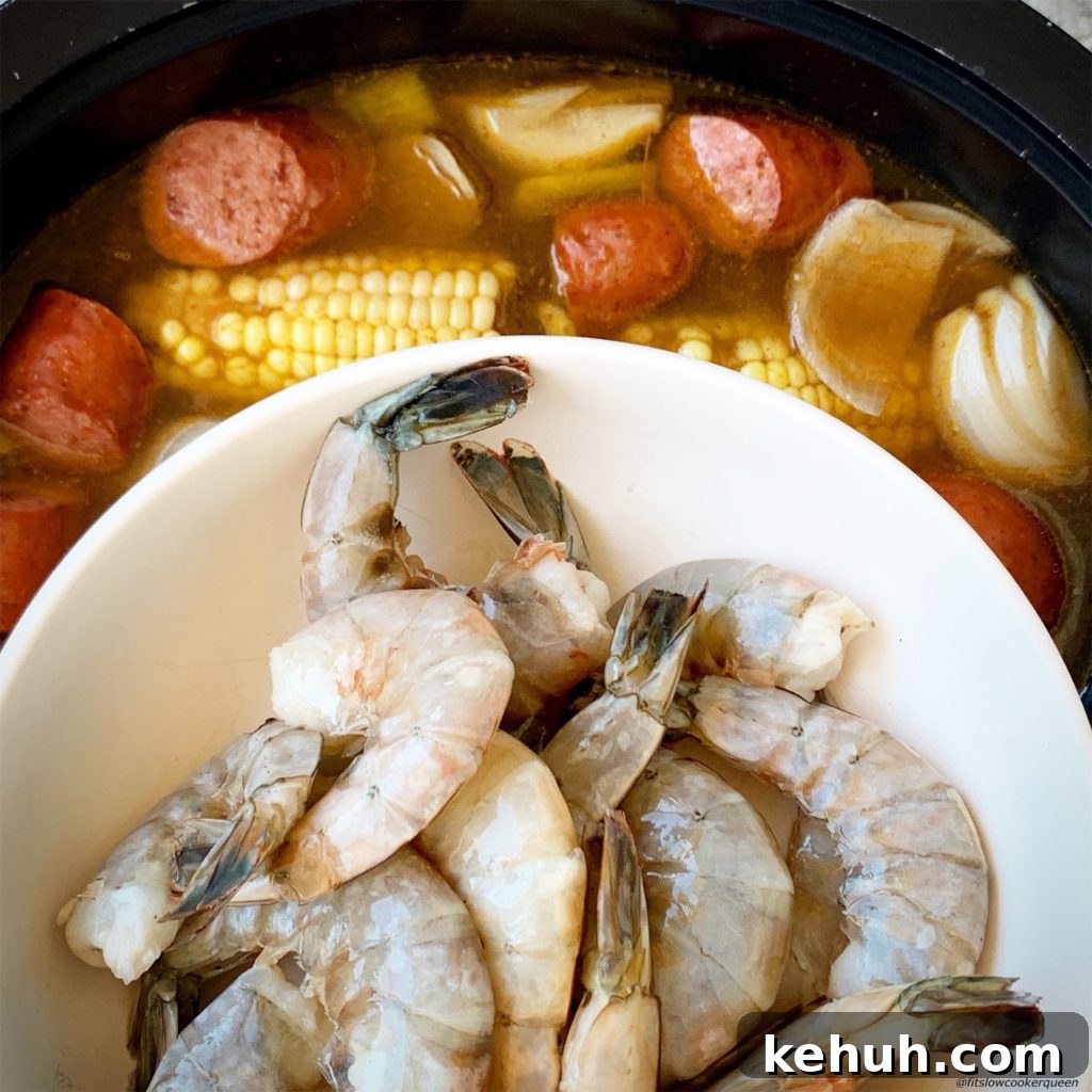 overhead shot of adding shrimp to the black slow cooker