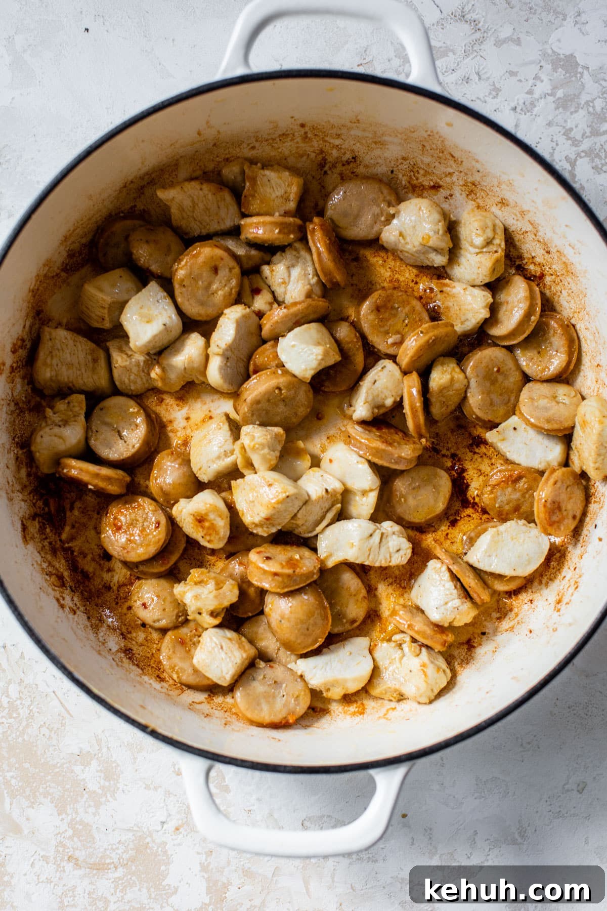 Authentic Chicken and Sausage Jambalaya Recipe for Packed Flavor 3 chicken and sausage pieces in a dutch oven