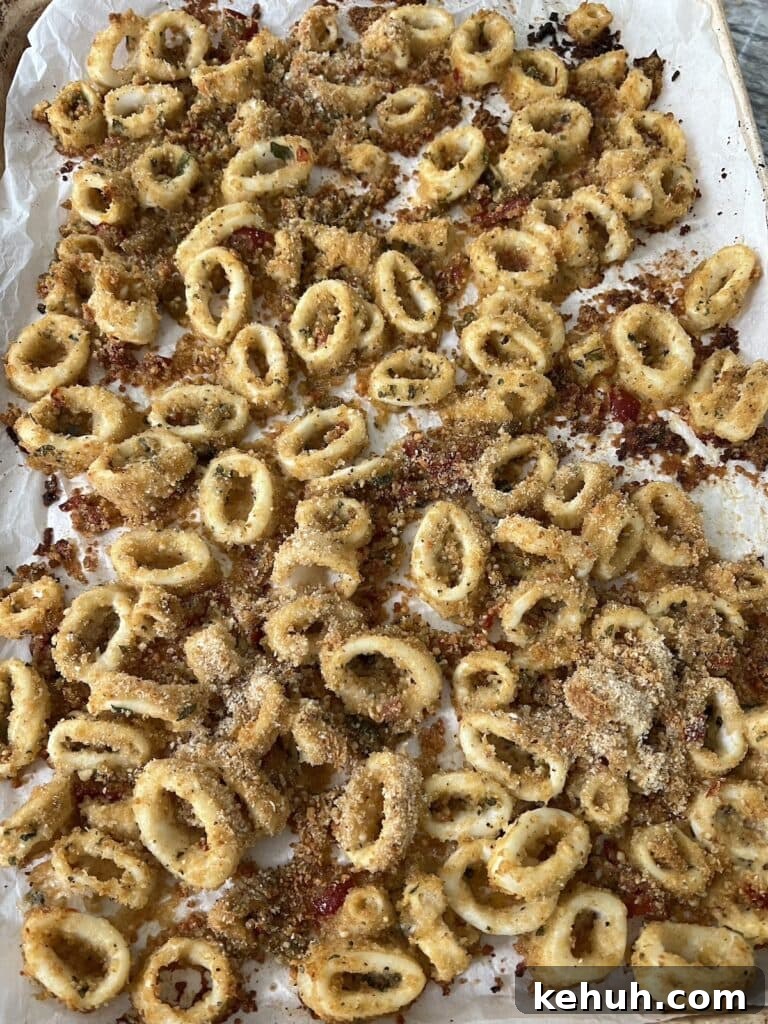 Crispy Baked Calamari: Oven-Fried Taste Without Deep Frying 8 Finished crispy oven fried calamari on sheet pan.