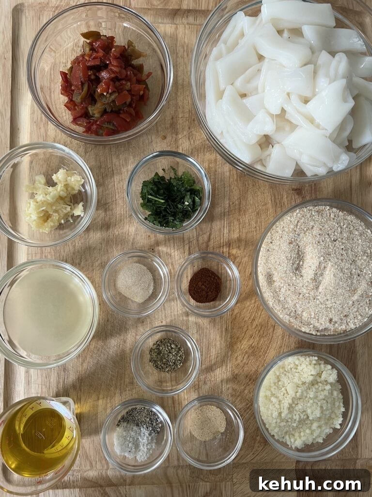 Crispy Baked Calamari: Oven-Fried Taste Without Deep Frying 6 All prepped ingredients for recipe in glass bowls on cutting board.
