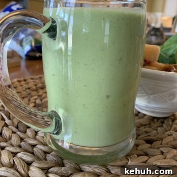 Refreshing Sweet Green Smoothie Recipe for Energy and Glow 13 Smoothie in a large glass cup.