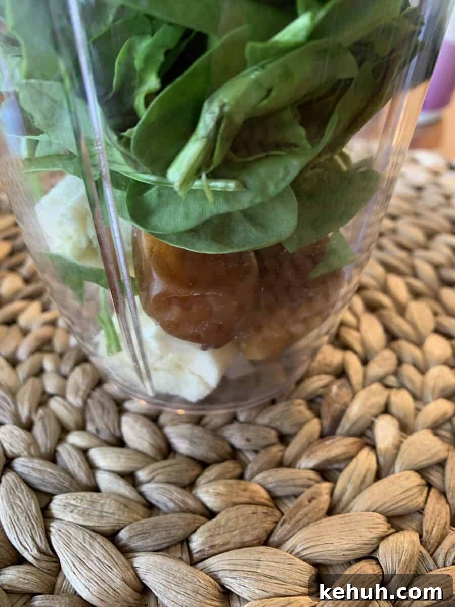 Refreshing Sweet Green Smoothie Recipe for Energy and Glow 6 Spinach, dates and banana in a blender cup.