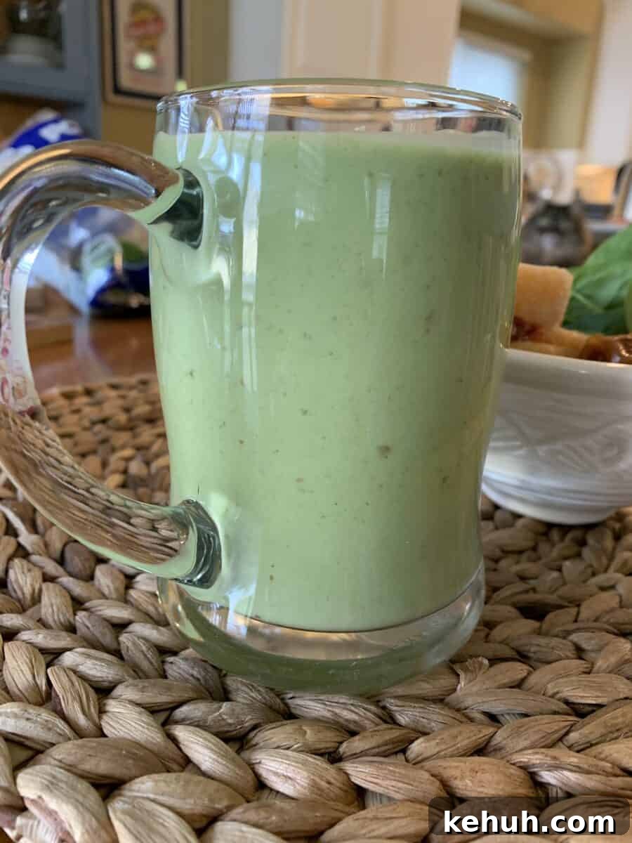 Refreshing Sweet Green Smoothie Recipe for Energy and Glow 10 Smoothie in a large glass cup.