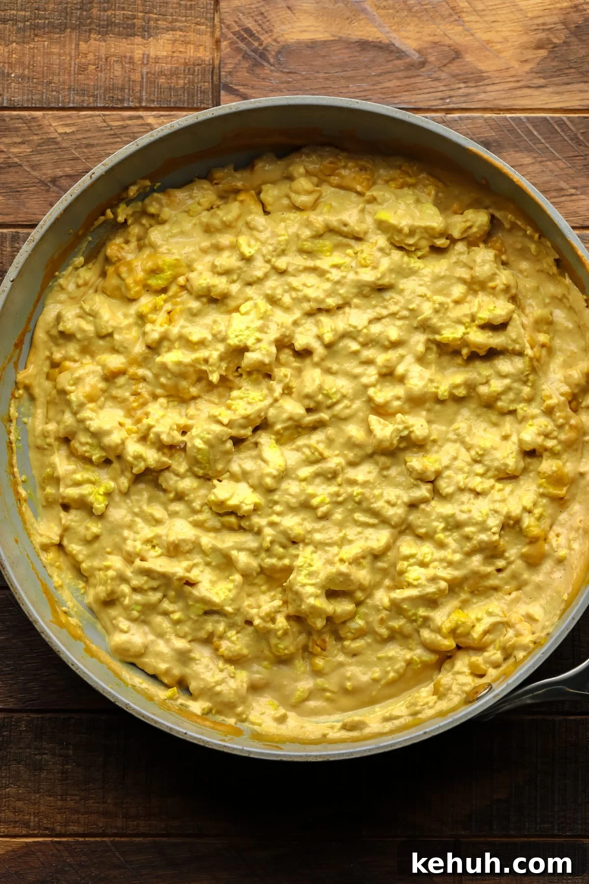 High-Protein Vegan Breakfast Burritos for Busy Mornings 5 egg looking yellow mixture in pan on wood board