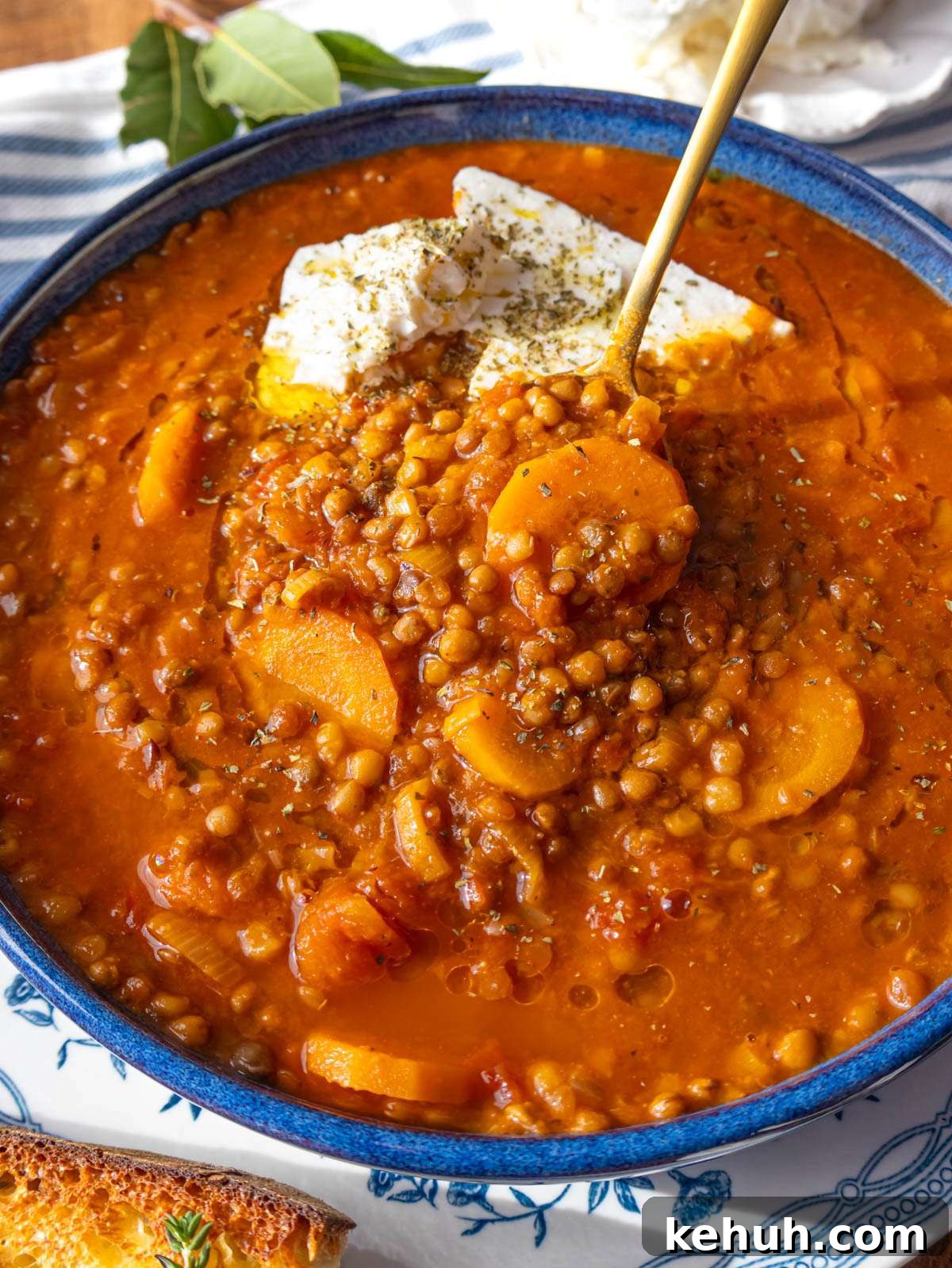 Authentic Greek Lentil Soup (Fakes) — Simple, Flavorful Recipe 2 Close up of Greek lentil soup with olive oil drizzle and feta on top.