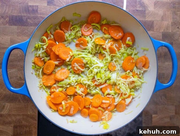 Authentic Greek Lentil Soup (Fakes) — Simple, Flavorful Recipe 9 Step 1 Sautéing onion carrot and leek in olive oil in a large pot.