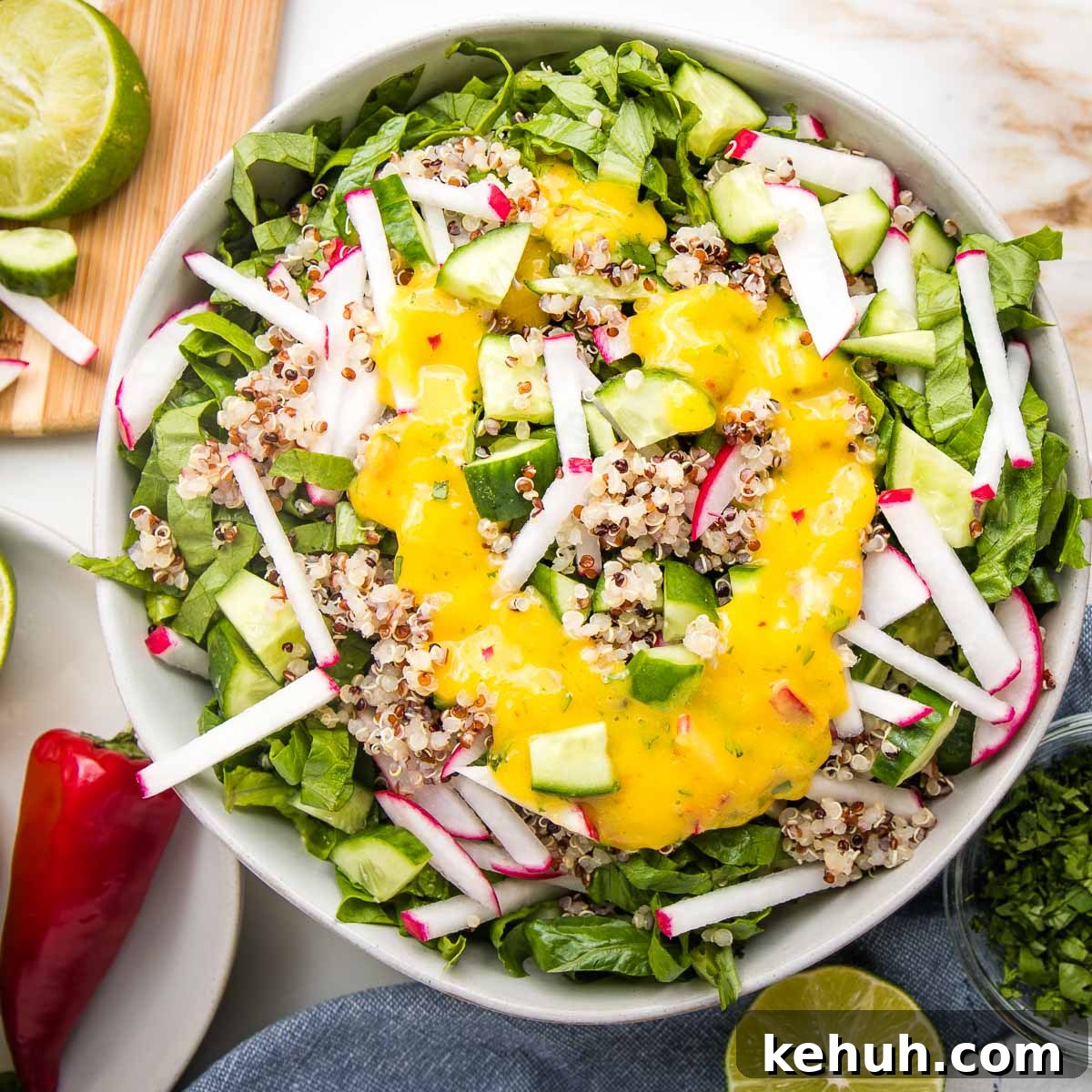 Vibrant Vegan Mango Salad Dressing Recipe for Fresh Salads 15 Bright yellow mango dressing pouted onto a simple green and grain salad.