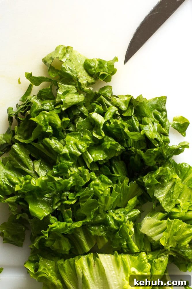 5-Ingredient BLT Chicken Salad Recipe for Quick Lunch 7 cutting up leaves of green lettuce