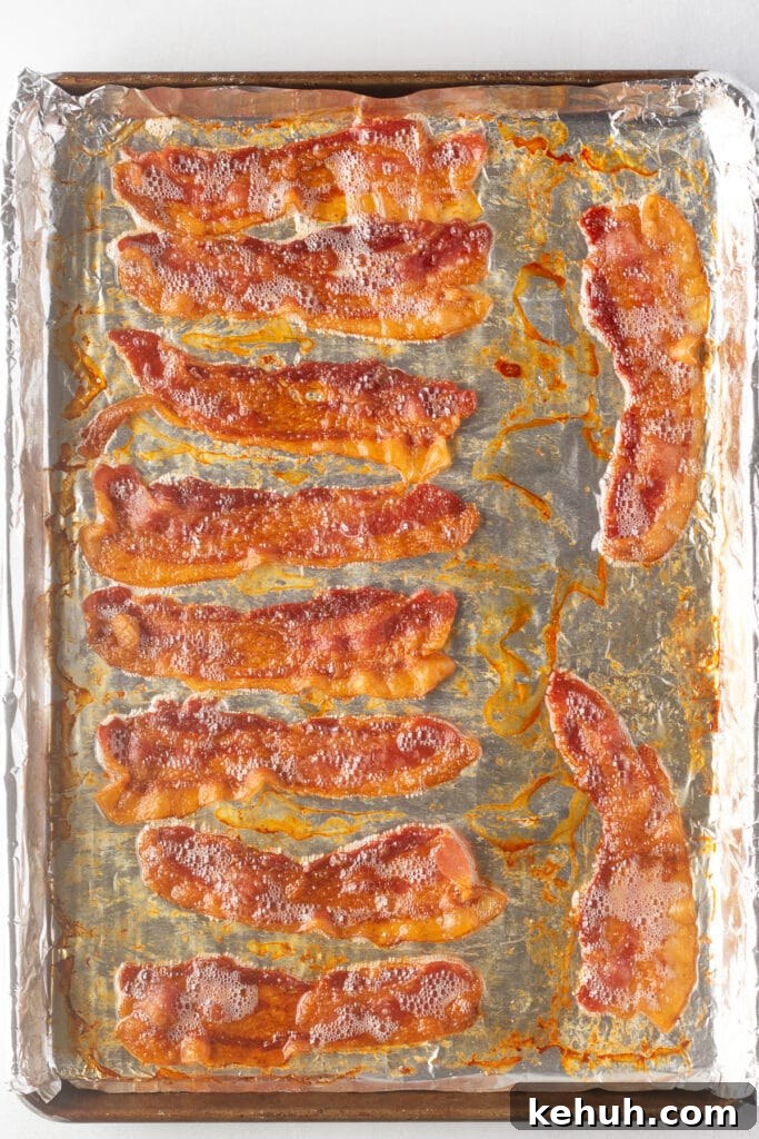 5-Ingredient BLT Chicken Salad Recipe for Quick Lunch 8 Top down shot of cooked chicken on a foil-lined sheet pan.