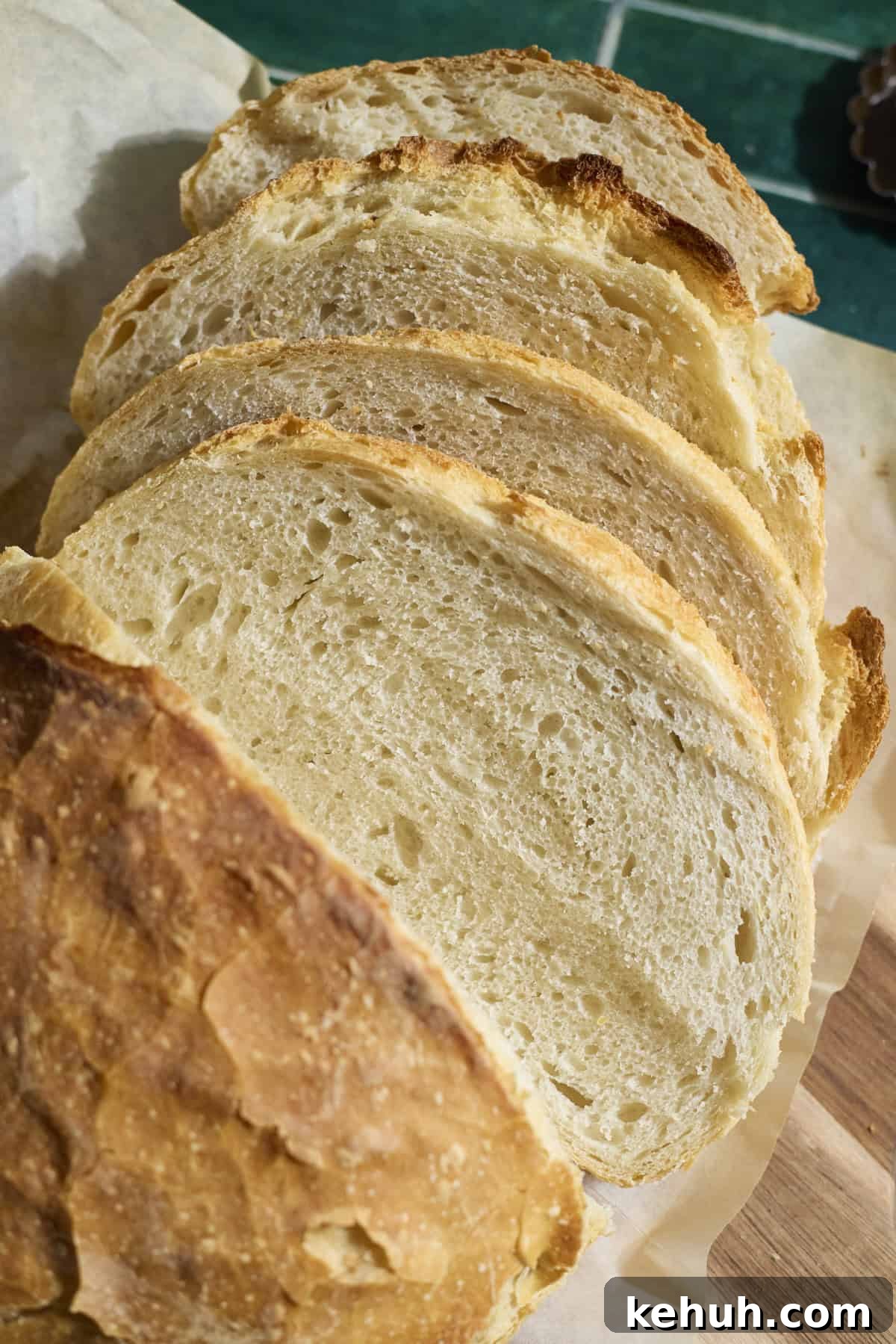 Sourdough Discard Bread Recipe: Crispy Crust, Soft Crumb 2 Slices of a Sourdough Discard Bread on a cutting board.