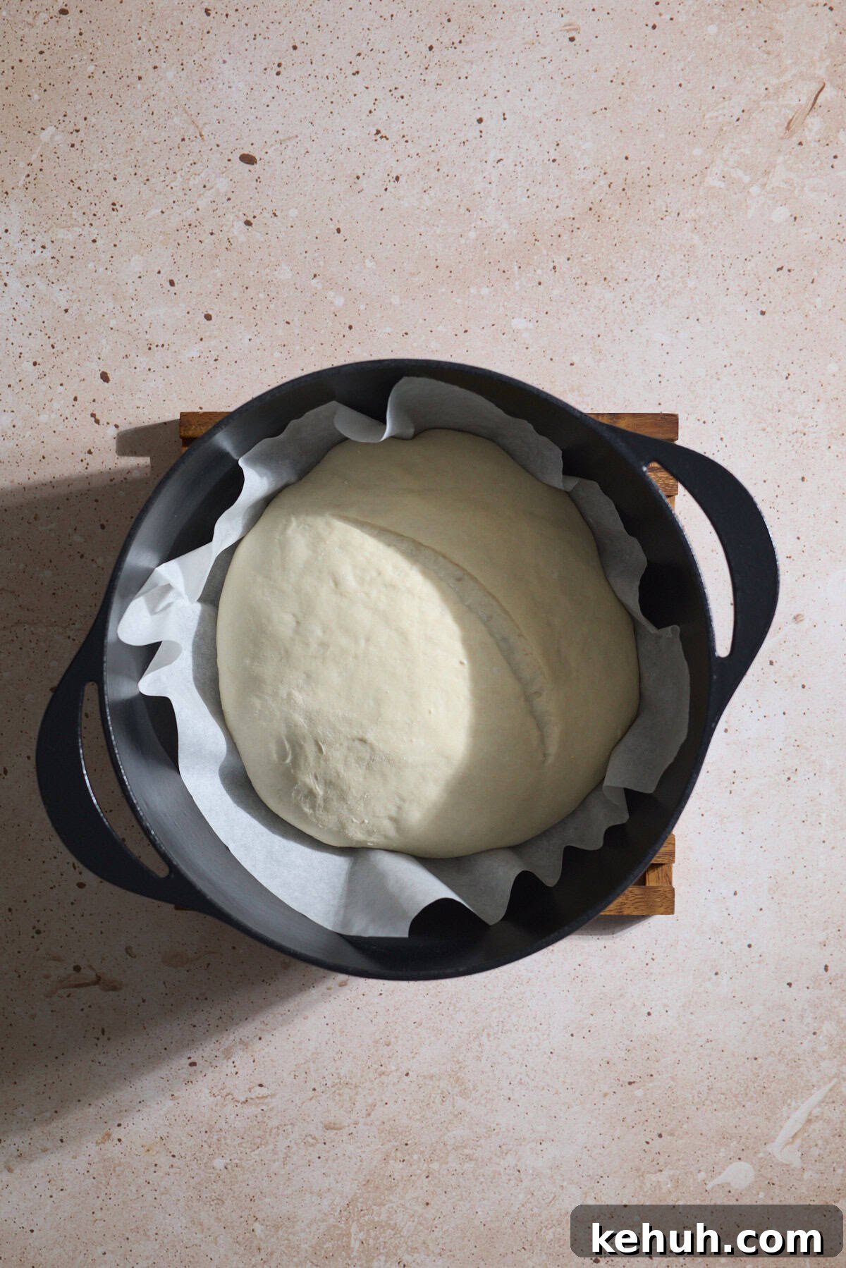 Sourdough Discard Bread Recipe: Crispy Crust, Soft Crumb 10 Scored loaf set into a Dutch Oven.