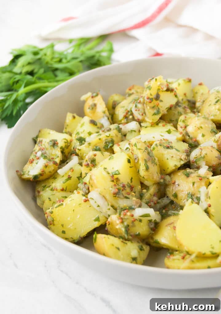 Close up of the mustard potato salad in a white bowl
