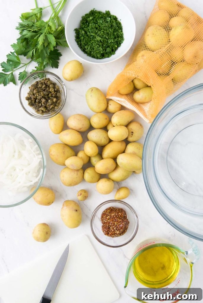 Gold potatoes with other vegan potato salad ingredients on a countertop
