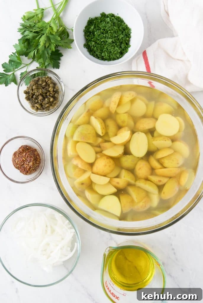 Chopped gold potatoes sit in a bowl full of water