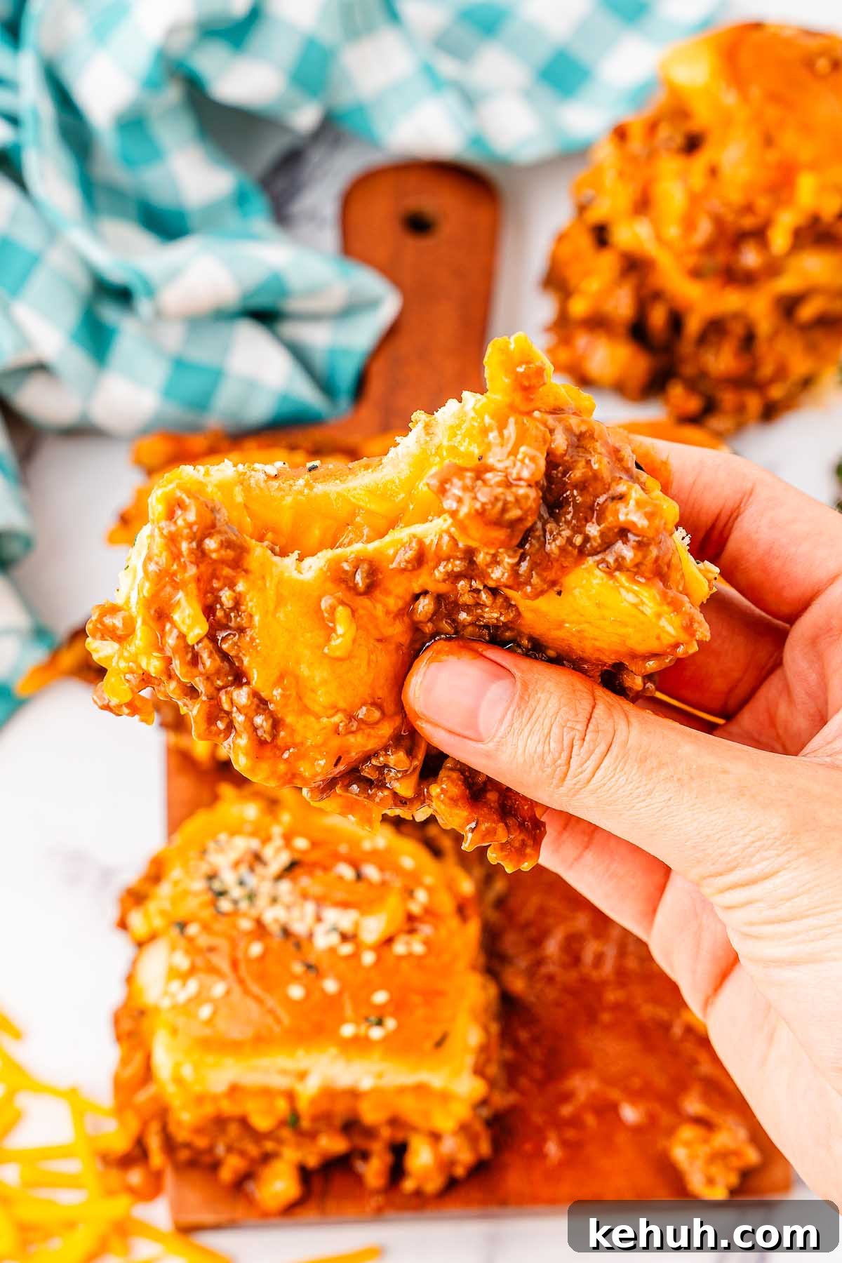 Savory Sloppy Joe Sliders Recipe for Game Day and Parties 6 Hand holding a sloppy joe slider.