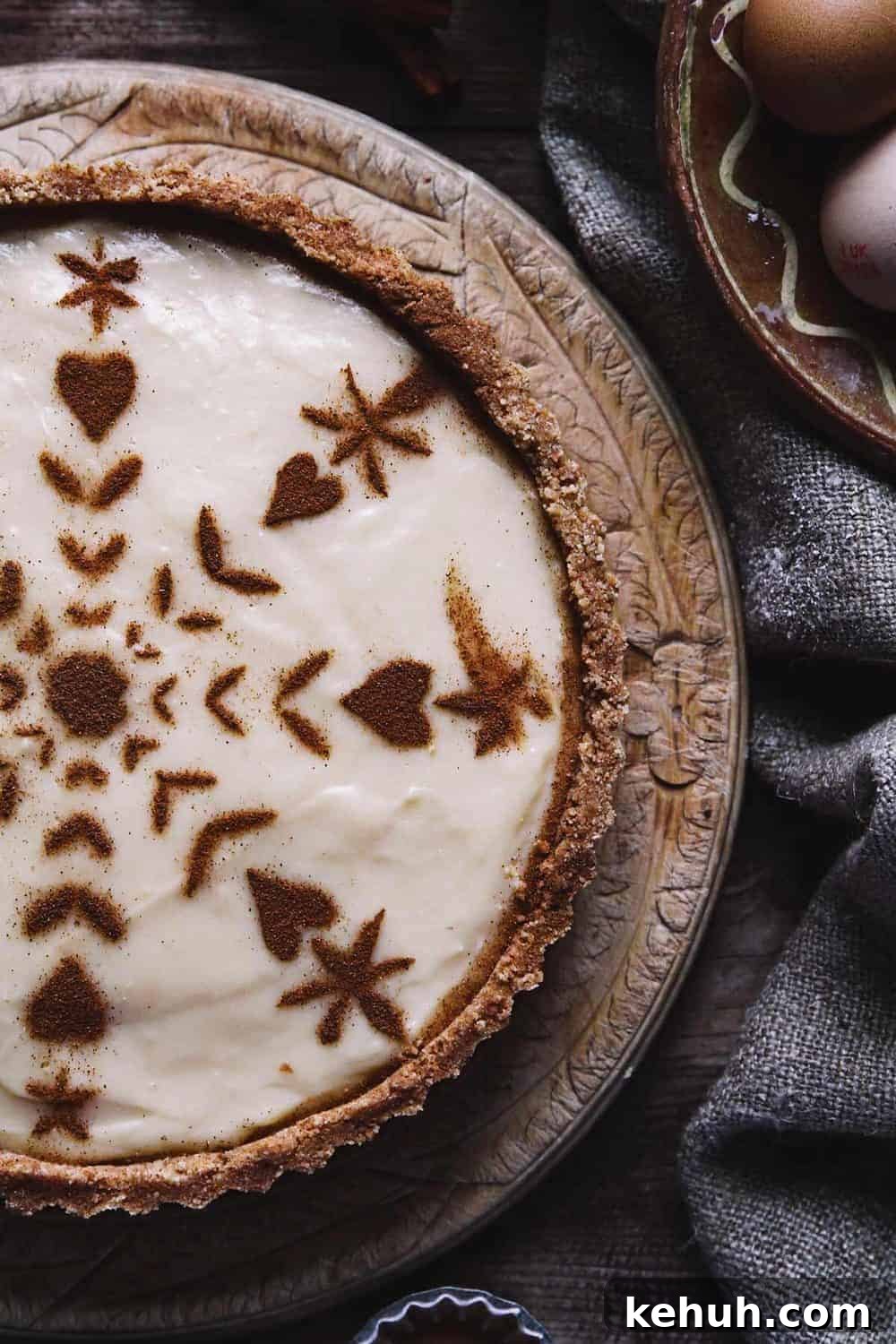 A close up of classic creamy African tart with cinnamon pattern on the top.