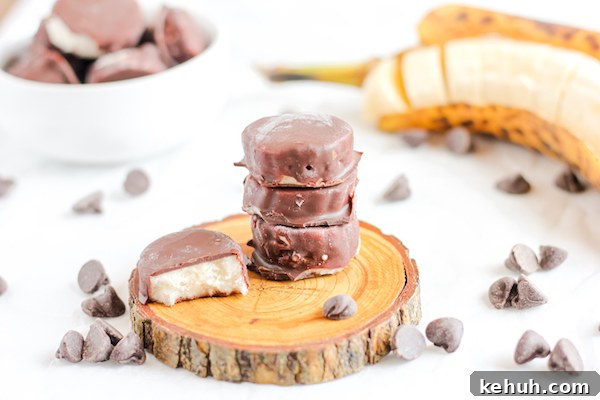 Image shows several chocolate-covered banana bites stacked