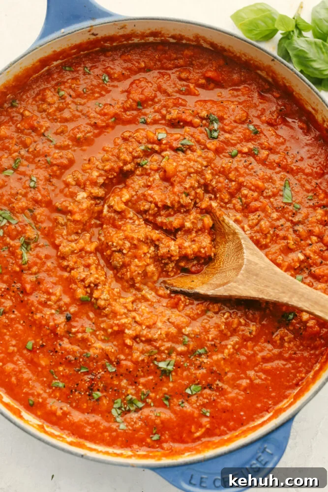 Bolognese sauce with a wooden spoon. 
