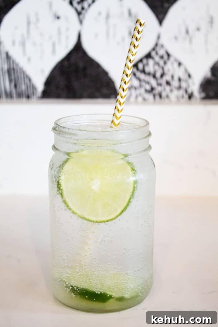 Keto 4th of July Recipes for Your Patriotic Cookout 89 mason jar on countertop filled with vodka soda and lime slices and straw