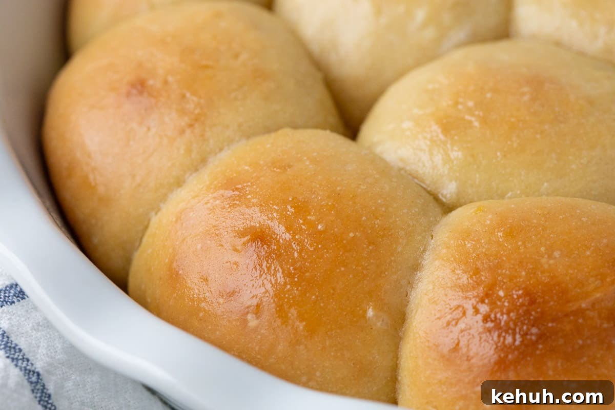 Fluffy Mashed Potato Dinner Rolls: Soft, Buttery Recipe 12 buttery dinner rolls in a white dish.