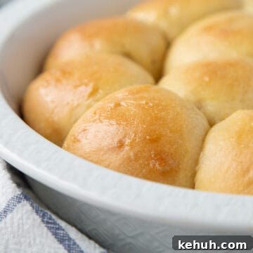 Fluffy Mashed Potato Dinner Rolls: Soft, Buttery Recipe 13 potato rolls in a round white dish.