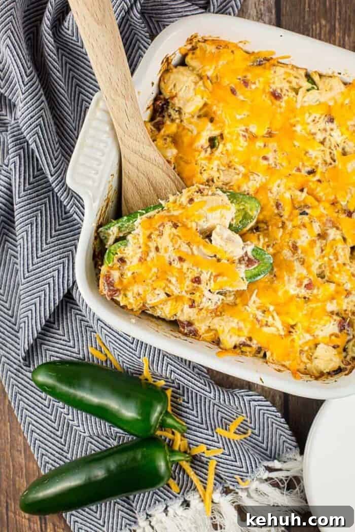 Keto 4th of July Recipes for Your Patriotic Cookout 29 white casserole dish containing keto jalapeño popper chicken casserole next to jalapeños