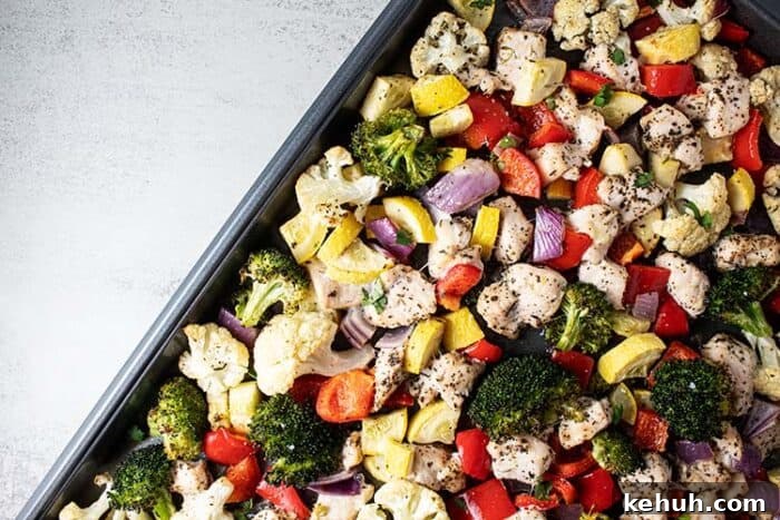 Keto 4th of July Recipes for Your Patriotic Cookout 31 overhead view of roasted chicken and vegetables on metal sheet pan out of the oven