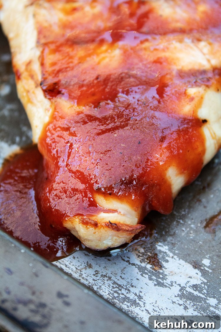 Keto 4th of July Recipes for Your Patriotic Cookout 5 keto bbq chicken smothered with sauce on baking sheet