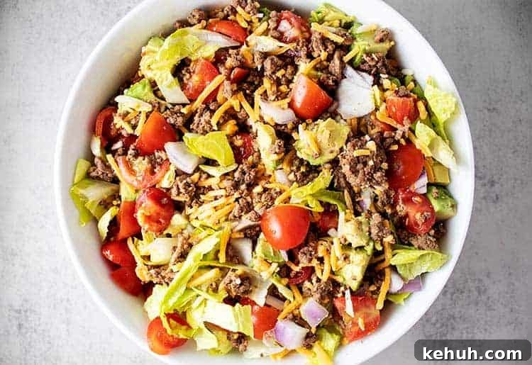 Keto 4th of July Recipes for Your Patriotic Cookout 39 overhead view of taco salad mixed together in a white bowl