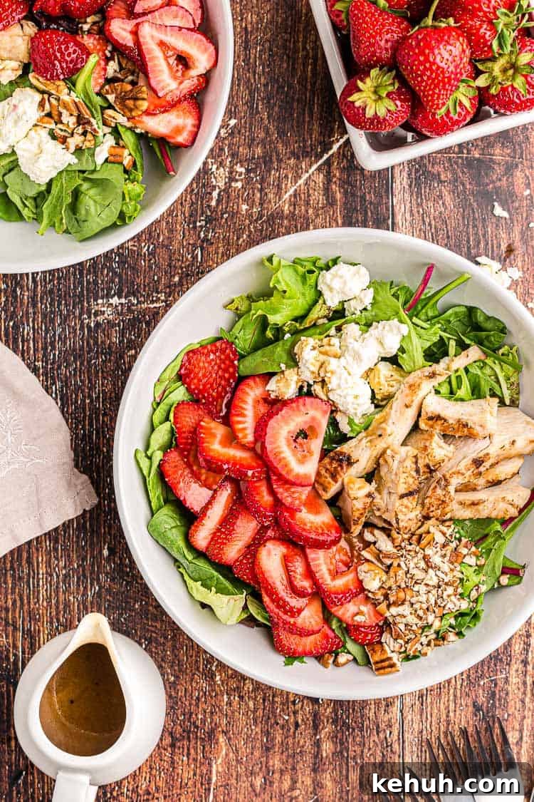 Keto 4th of July Recipes for Your Patriotic Cookout 43 overhead view of keto strawberry chicken salad next to a bowl of fresh strawberries