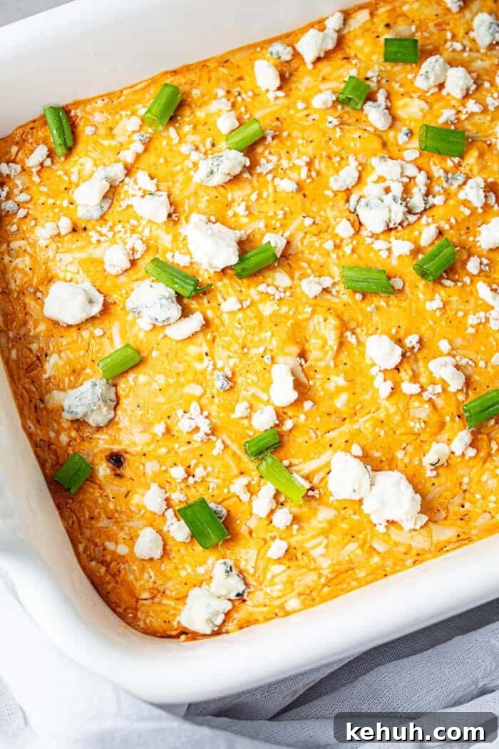 Keto 4th of July Recipes for Your Patriotic Cookout 47 overhead view of white cassserole dish with orange colored keto buffalo chicken dip