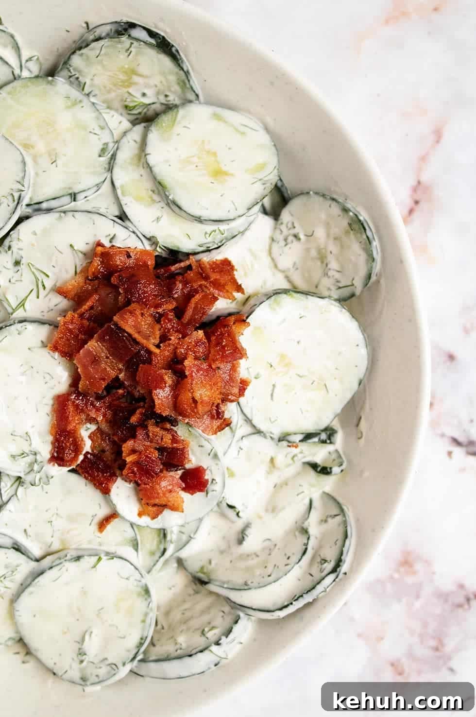Keto 4th of July Recipes for Your Patriotic Cookout 55 overhead view of keto cucumber salad with crumbled bacon on top