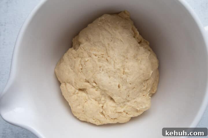 Fluffy Mashed Potato Dinner Rolls: Soft, Buttery Recipe 8 potato roll dough in a white bowl.
