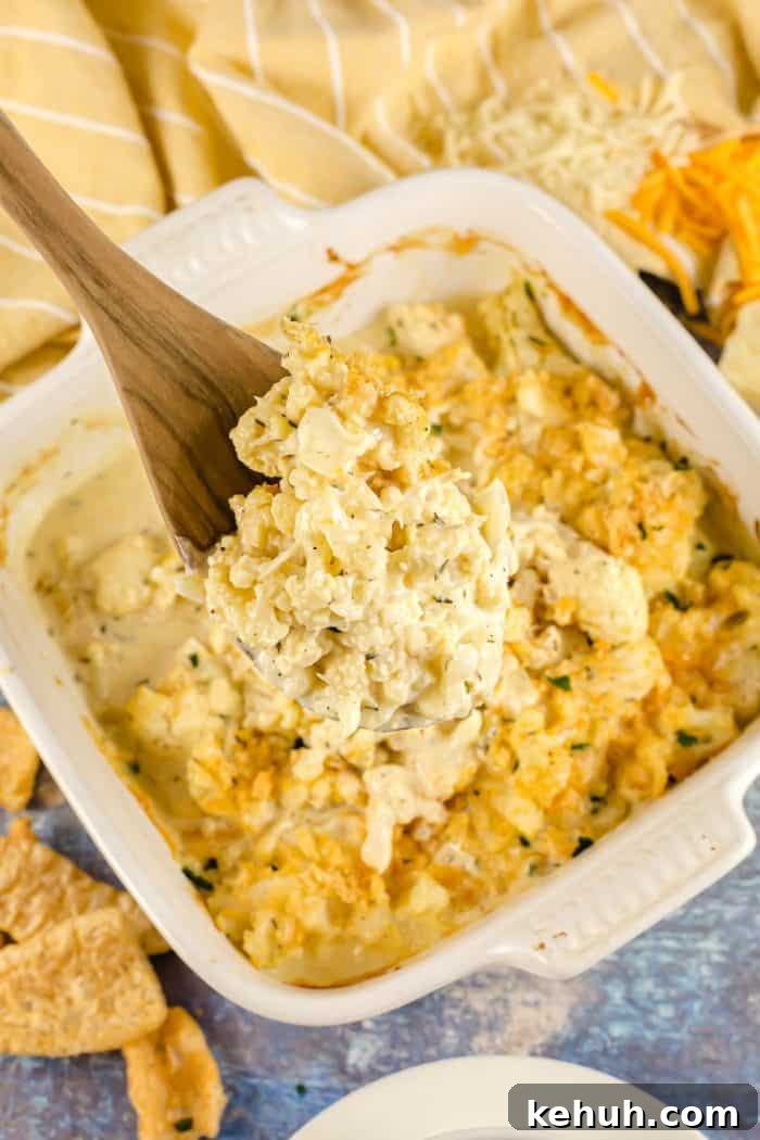 Keto 4th of July Recipes for Your Patriotic Cookout 63 wooden spoon with part of keto cauliflower mac and cheese on it