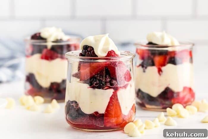 Keto 4th of July Recipes for Your Patriotic Cookout 75 closeup view of three glass jars containing keto white chocolate mousse layered with berries
