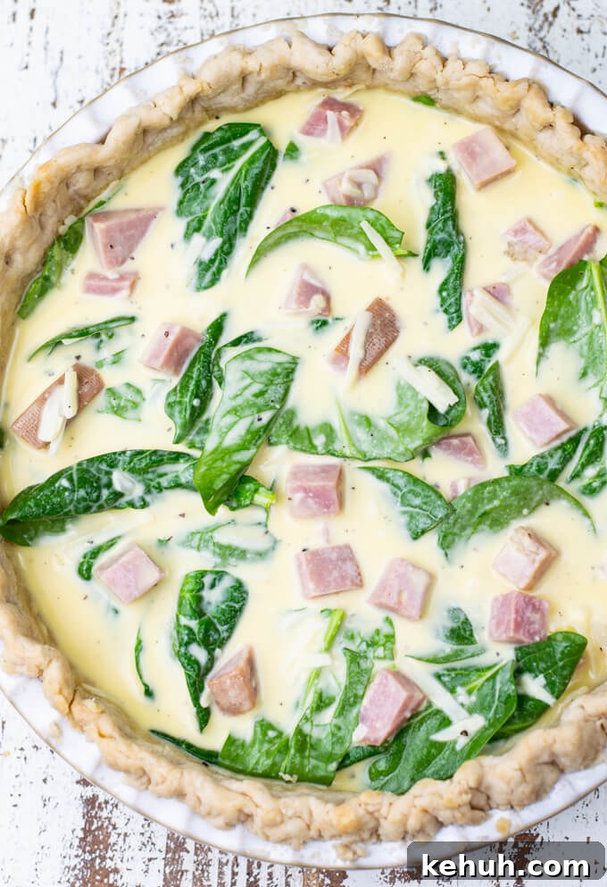 Spinach, Ham & Cheese Quiche Recipe for Brunch and Weeknights 5 An unbaked ham and cheese quiche with spinach.