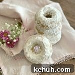 Baked Powdered Sugar Donuts stacked on a white napkin