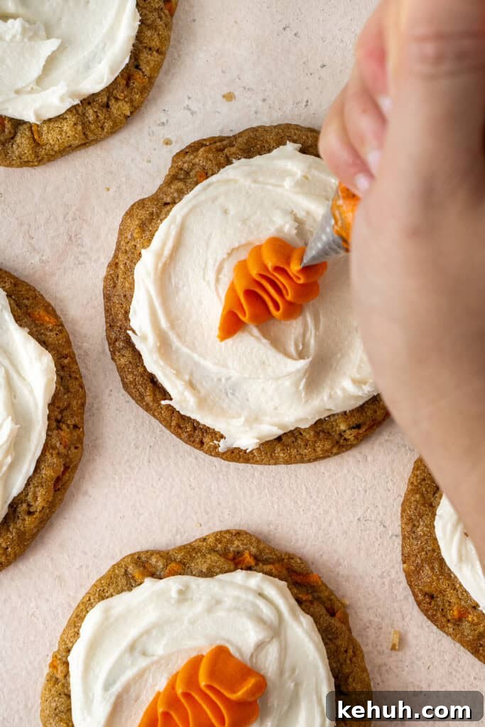 Piping the carrots on the frosted cookies.