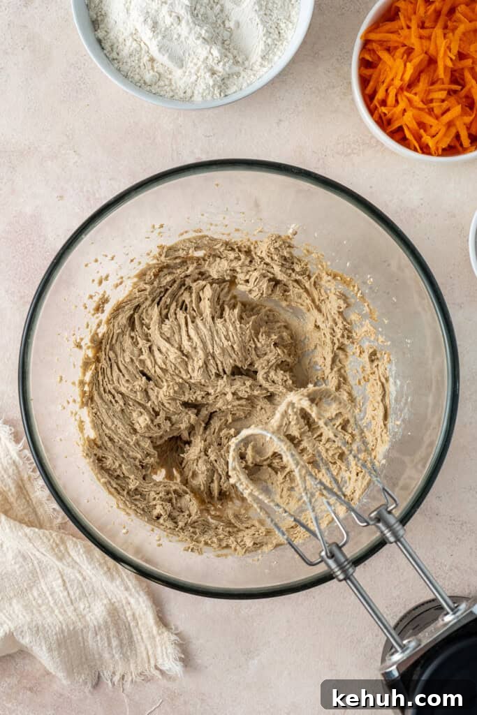 Mixing together the cookie dough with a hand mixer.