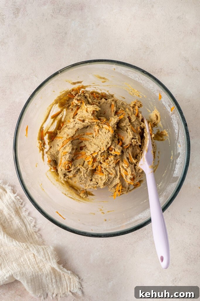 The cookie dough in a bowl with a spatula.