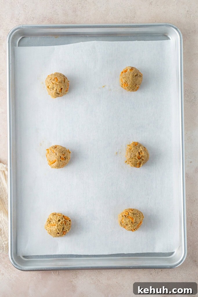 Balls of cookie dough on a baking tray.